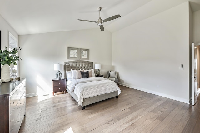 bedroom featuring wood finished floors, lofted ceiling, baseboards, and a ceiling fan