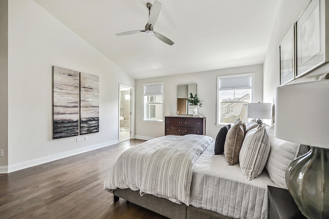 bedroom with baseboards, lofted ceiling, a ceiling fan, wood finished floors, and connected bathroom
