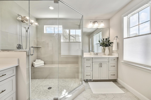 bathroom with a stall shower, vanity, marble finish floor, baseboards, and recessed lighting