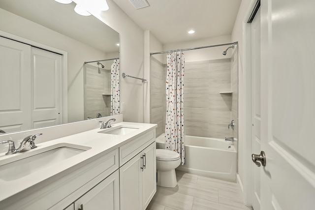 bathroom with visible vents, shower / bath combination with curtain, a sink, and toilet