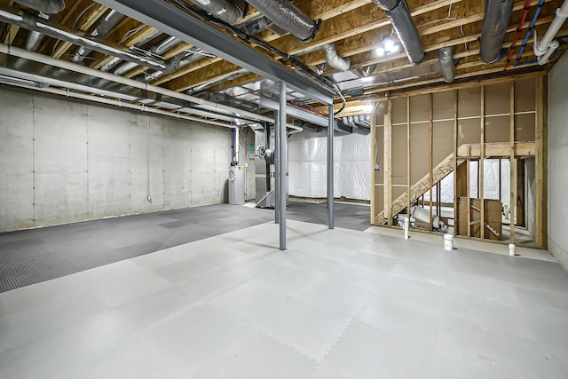 unfinished below grade area with water heater and stairway