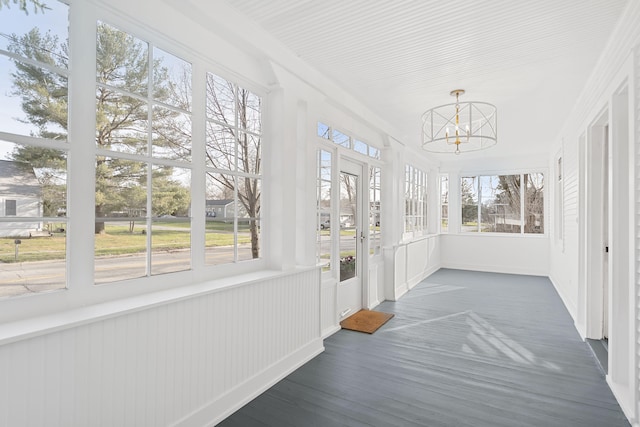 unfurnished sunroom featuring a notable chandelier