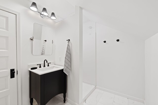 full bathroom featuring vanity, marble finish floor, baseboards, and a walk in shower