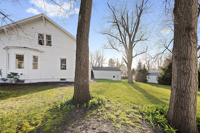 view of side of home featuring crawl space and a yard