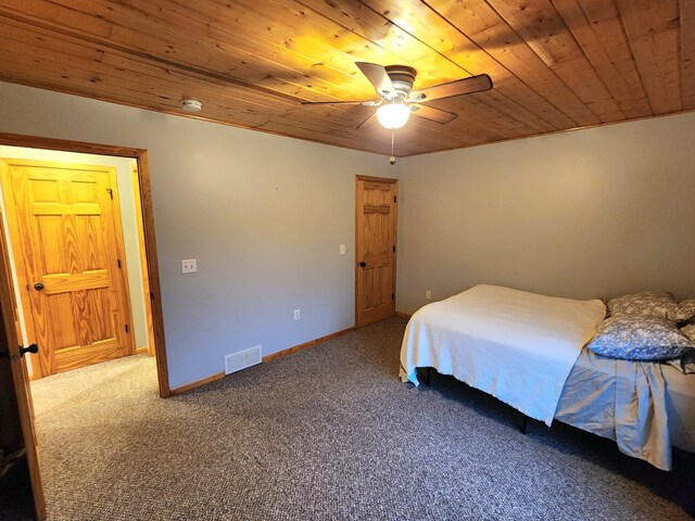 6039 W Morris Lake Rd, Mears, MI 49436 - bedroom with baseboards, visible vents, carpet, ceiling fan, and wooden ceiling