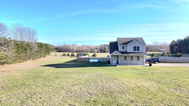 6039 W Morris Lake Rd, Mears, MI 49436 - view of home's exterior with a lawn, fence, and covered porch
