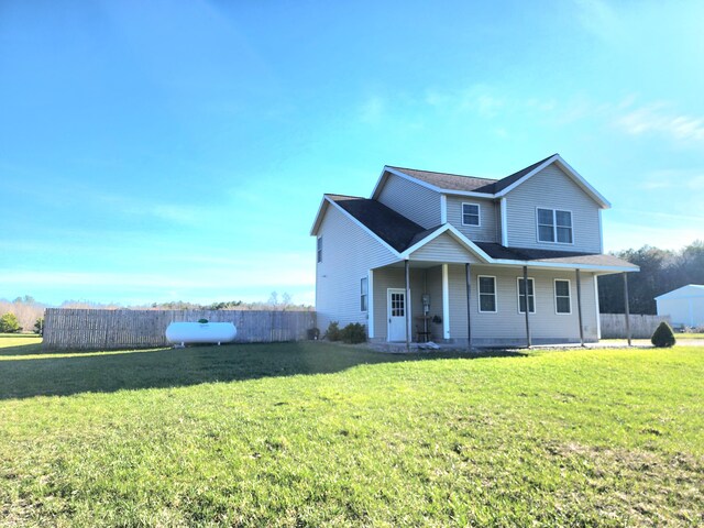 6039 W Morris Lake Rd, Mears, MI 49436 - traditional-style home with fence and a front lawn