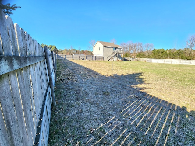 6039 W Morris Lake Rd, Mears, MI 49436 - view of yard featuring a fenced backyard and stairway