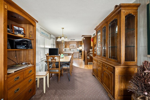 5505 Lakewood Dr, Coloma, MI 49038 - dining area featuring visible vents, dark carpet, and a chandelier