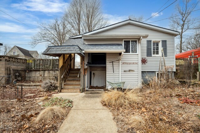 5505 Lakewood Dr, Coloma, MI 49038 - view of front of property with fence and a shingled roof