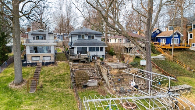 5505 Lakewood Dr, Coloma, MI 49038 - rear view of property featuring stairway, a balcony, a vegetable garden, a wooden deck, and a residential view