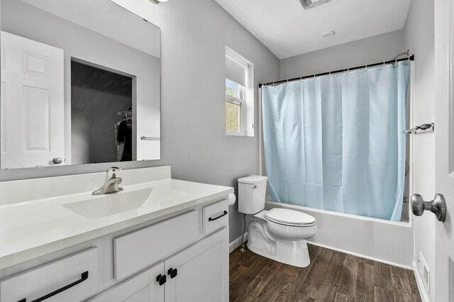 5849 Gavin Ln, Kalamazoo, MI 49009 - full bath with shower / bath combination with curtain, toilet, wood finished floors, visible vents, and vanity