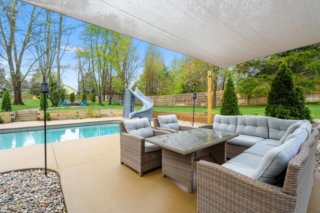 5849 Gavin Ln, Kalamazoo, MI 49009 - exterior space with an outdoor living space, a fenced in pool, a patio area, a water slide, and a fenced backyard