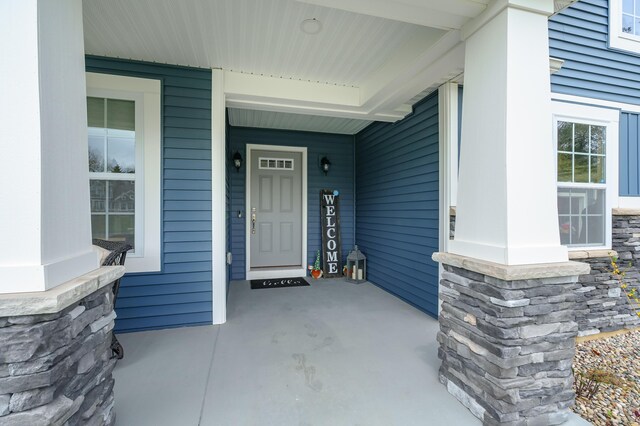 5849 Gavin Ln, Kalamazoo, MI 49009 - property entrance featuring stone siding and a porch