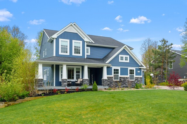 5849 Gavin Ln, Kalamazoo, MI 49009 - view of front facade featuring a porch, a front lawn, stone siding, and board and batten siding