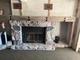 4605 Hunters Trl, Six Lakes, MI 48886 - detailed view of a stone fireplace and carpet