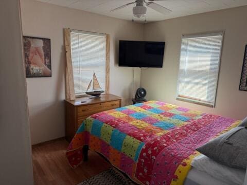 4605 Hunters Trl, Six Lakes, MI 48886 - bedroom featuring wood finished floors and ceiling fan