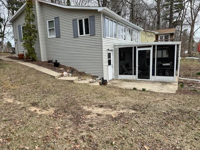 4605 Hunters Trl, Six Lakes, MI 48886 - view of side of home featuring a sunroom
