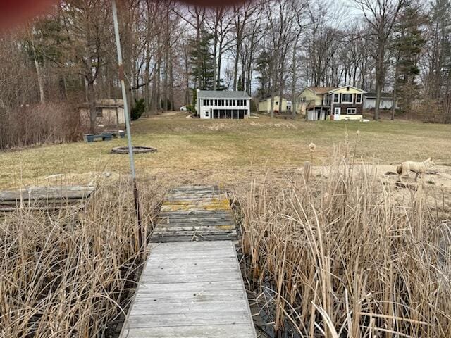 4605 Hunters Trl, Six Lakes, MI 48886 - dock area with view of wooded area