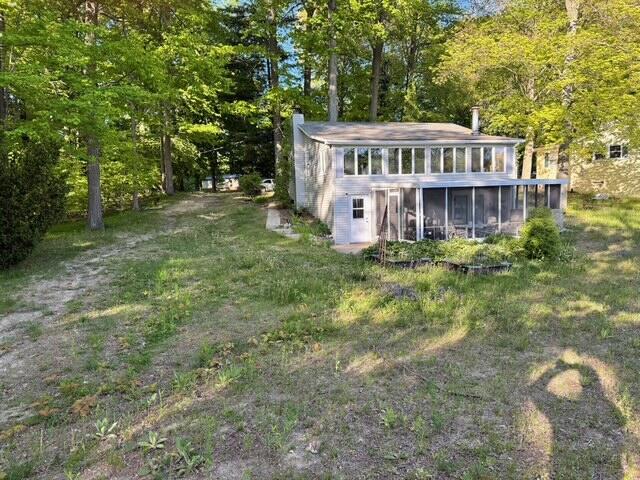 4605 Hunters Trl, Six Lakes, MI 48886 - view of outbuilding with a sunroom and a forest view