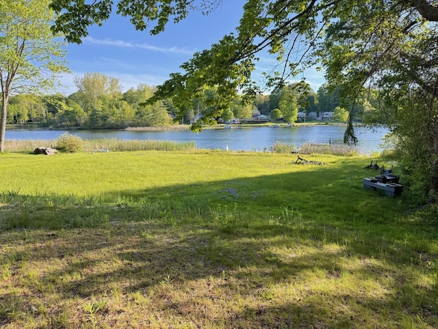 4605 Hunters Trl, Six Lakes, MI 48886 - view of green lawn with a water view