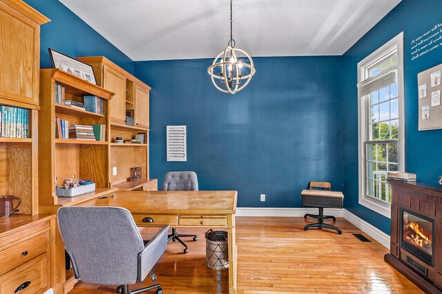 7812 Fountain Hills Ln, Davisburg, MI 48350 - office with wood-type flooring, a chandelier, baseboards, and a glass covered fireplace