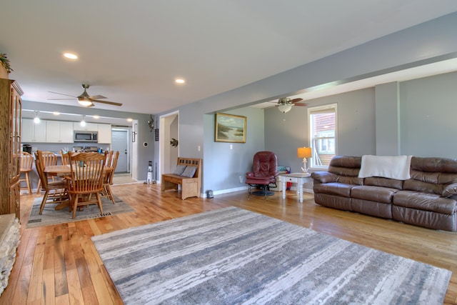4790 Downing Dr, Pinckney, MI 48169 - living area featuring ceiling fan, baseboards, light wood finished floors, and recessed lighting