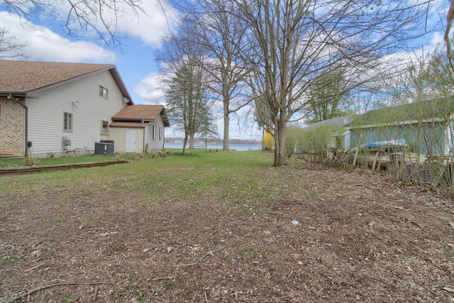 4790 Downing Dr, Pinckney, MI 48169 - view of yard with central AC and a water view