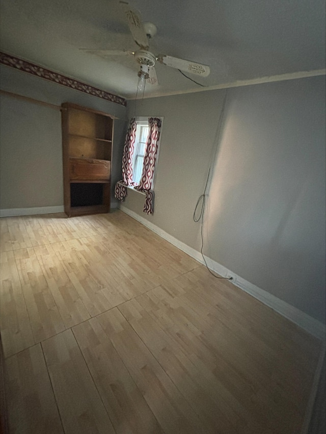 215 E Liberty Rd, Cement City, MI 49233 - unfurnished living room featuring baseboards, a ceiling fan, and light wood finished floors