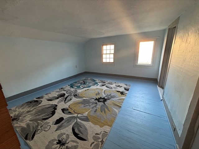 215 E Liberty Rd, Cement City, MI 49233 - bonus room with baseboards, wood finished floors, and lofted ceiling