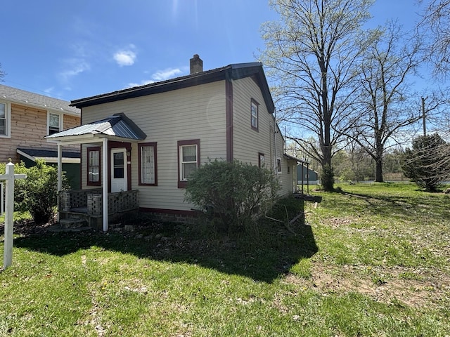 215 E Liberty Rd, Cement City, MI 49233 - traditional home featuring a front lawn and a chimney