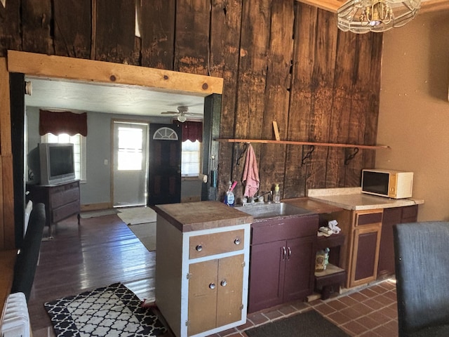 215 E Liberty Rd, Cement City, MI 49233 - kitchen featuring open shelves, a sink, white microwave, dark wood-style floors, and radiator