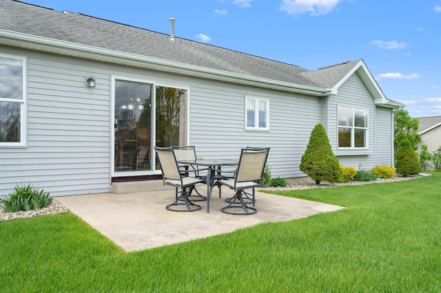 51441 Jordan St, Paw Paw, MI 49079 - rear view of property featuring a patio area, a lawn, and a shingled roof