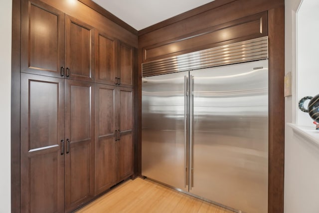 kitchen featuring light wood finished floors and stainless steel built in fridge