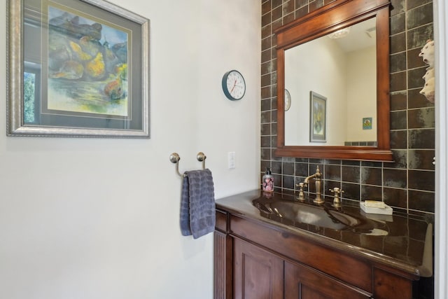 bathroom featuring vanity and backsplash