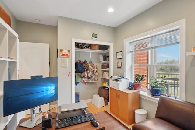 interior space featuring baseboards, light wood finished floors, and recessed lighting