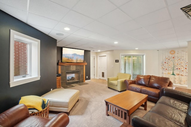 living area featuring recessed lighting, a paneled ceiling, a tiled fireplace, and carpet flooring