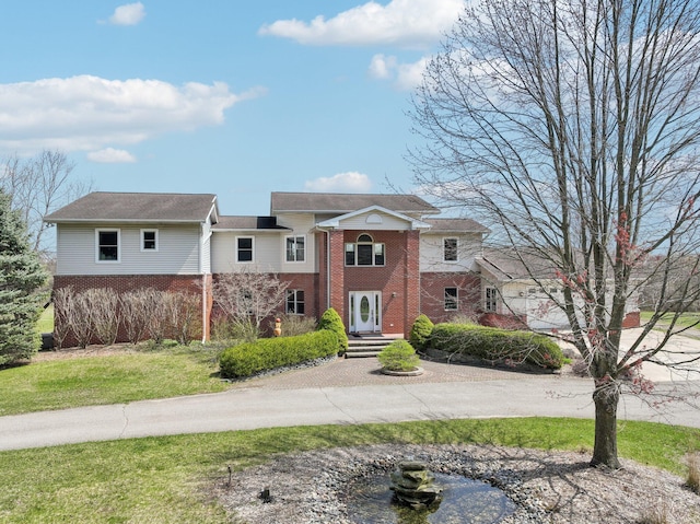 view of front of property with brick siding and a front yard