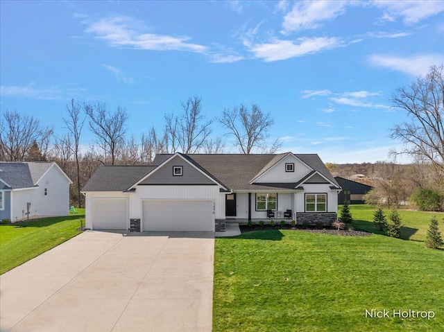 view of front of home featuring an attached garage, stone siding, a front lawn, and driveway