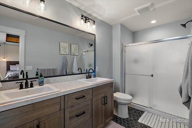 bathroom with a sink, toilet, ensuite bathroom, visible vents, and a shower stall