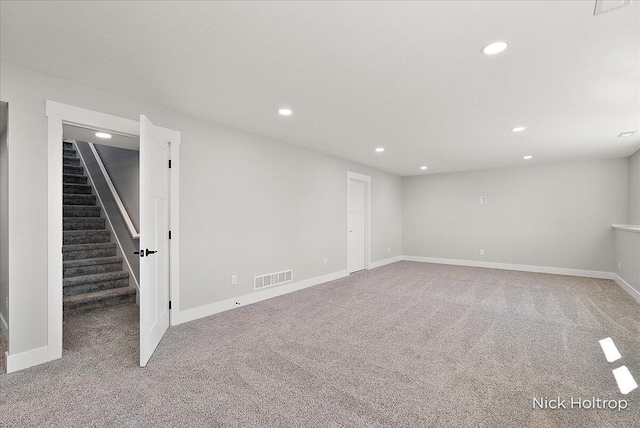 below grade area featuring recessed lighting, carpet floors, visible vents, and stairway
