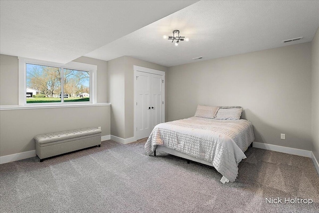 bedroom with baseboards, carpet flooring, and visible vents
