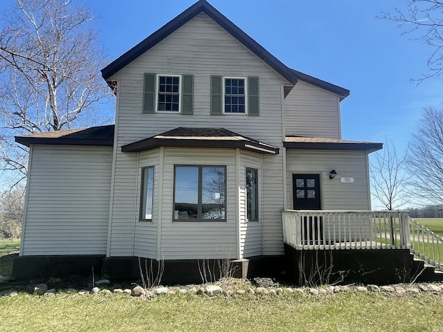 back of property with a wooden deck