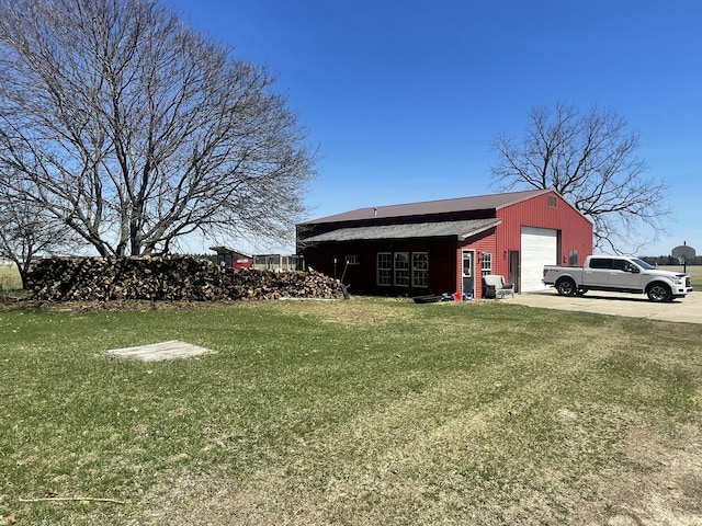 view of outbuilding featuring concrete driveway and an outbuilding