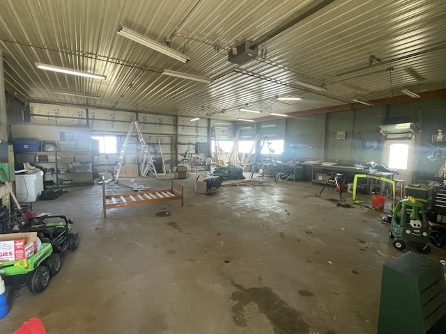 garage with a workshop area and a garage door opener