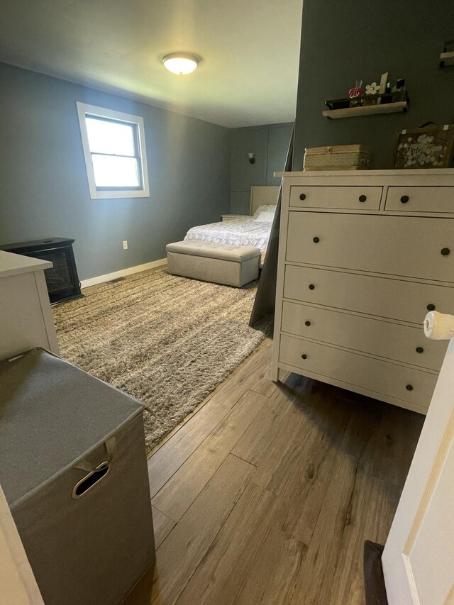 bedroom with baseboards and wood finished floors