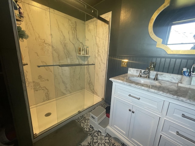 full bathroom featuring a shower stall, vanity, and tile patterned flooring