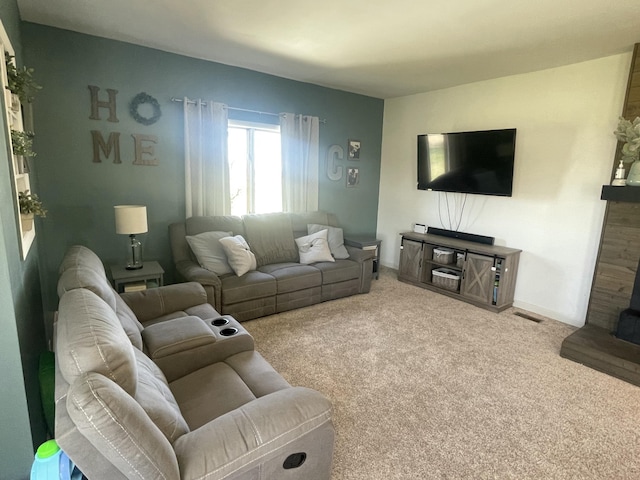 carpeted living room with baseboards