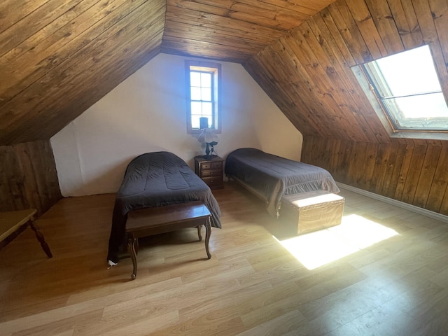 bedroom with vaulted ceiling, wood walls, wood ceiling, and wood finished floors