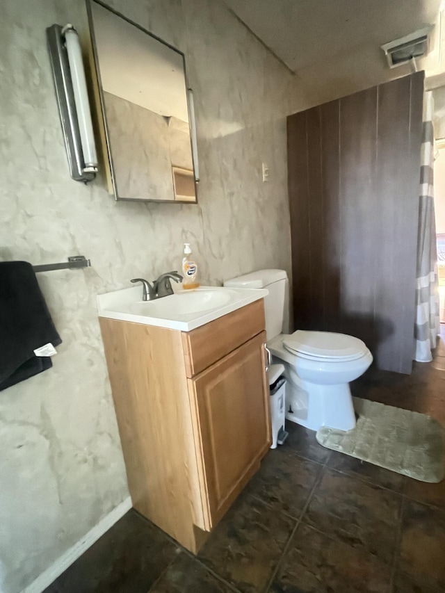 half bathroom featuring vanity and toilet
